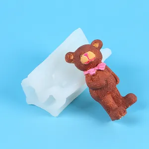 Detail view of 3D teddy bear silicone mold with a finished brown bear candle figure