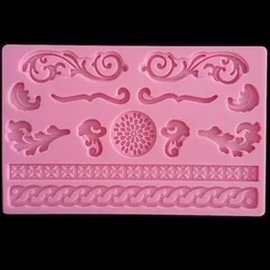Detailed macro view of a pink silicone mold featuring ornate baroque scrolls and floral patterns