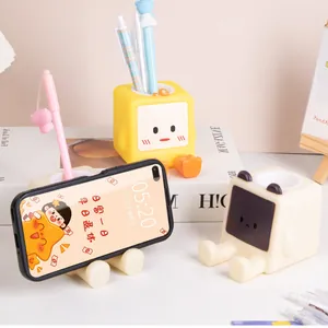 Portapenne multifunzionale a cartoni animati e supporto per telefono.