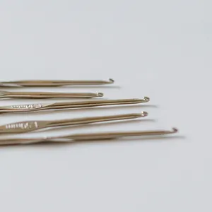 Close-up of stainless steel crochet hooks with engraved 1.30mm and 1.50mm sizes