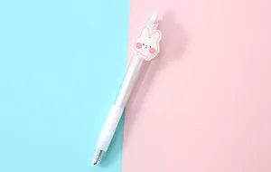Detail of a transparent gel pen featuring a cute pink cartoon bunny acrylic clip