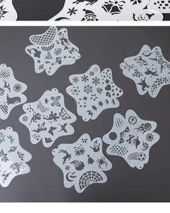Detail view of various star-shaped hollow plastic face painting stencil patterns and designs