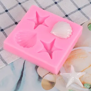 Detailed view of pink starfish and shell silicone mold with finished white pieces