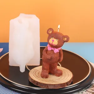 Close-up detail of 3D teddy bear silicone mold alongside a finished brown bear candle