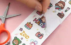 Close-up of peeling a waterproof transparent PVC cartoon sticker for DIY journals