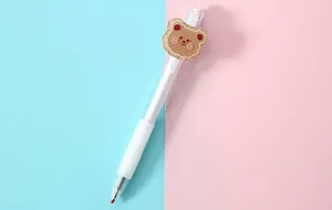 Macro close-up view of a cute cartoon bear patch on a transparent retractable gel pen