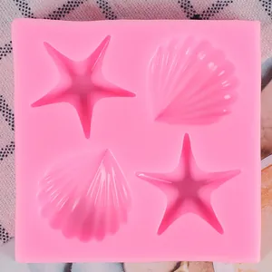 Top view of pink silicone mold with starfish and seashell shapes for fondant decoration
