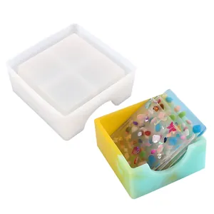 Square silicone mold alongside colorful resin storage box filled with decorated coasters.
