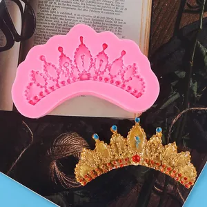 Detailed view of pink crown silicone mold and finished gold fondant crown decoration