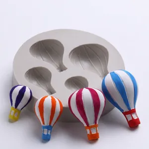 Detailed view of hot air balloon silicone mold with colorful fondant cake decorations