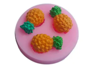 Detailed view of pink silicone mold with three pineapple shaped cavities for fondant