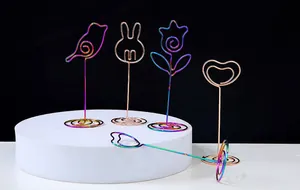 Detailed view of iridescent and rose gold metal card holders in cute animal shapes