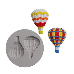Detail view of hot air balloon silicone mold with colorful fondant cake toppers.
