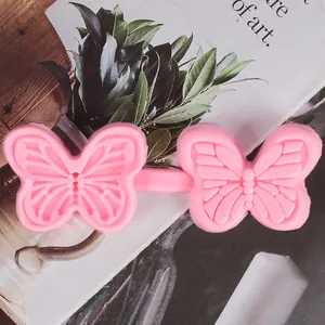 Close-up of pink butterfly silicone fondant mold with intricate butterfly wing patterns