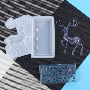 Detail view showing 3D reindeer silicone mold and sparkling blue resin finished pieces