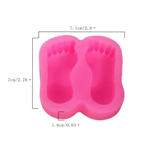 Pink silicone baby feet mold with dimension markers for fondant and cake decorating