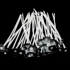 Detailed macro view of white cotton candle wicks with metal sustainers