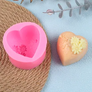 Macro view of pink heart silicone mold featuring LOVE and flower patterns for DIY