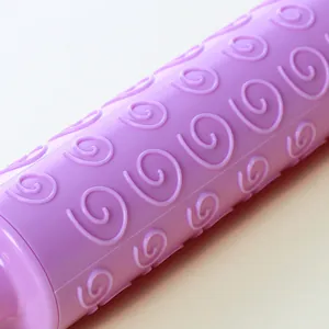 Close-up of purple plastic fondant rolling pin with spiral swirl patterns