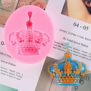 Detailed view of pink crown silicone mold with finished gold and blue resin piece