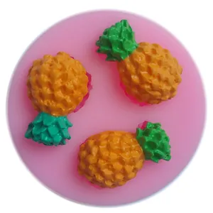 Detail view of pink silicone mold with three pineapple cavities for fondant