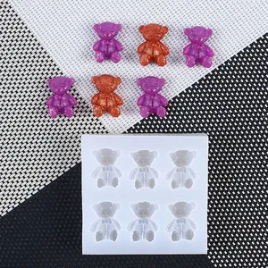 Detailed view of 6-cavity mini teddy bear silicone mold with colorful finished gummy bears