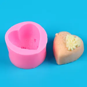 Detail view of heart-shaped pink silicone mold with finished floral soap sample product