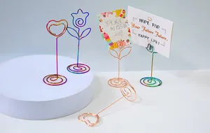 Assorted colorful metal wire memo clips in heart and tulip shapes with prop cards