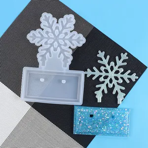 Detailed view of Christmas snowflake DIY resin silicone mold and finished glittery resin ornaments