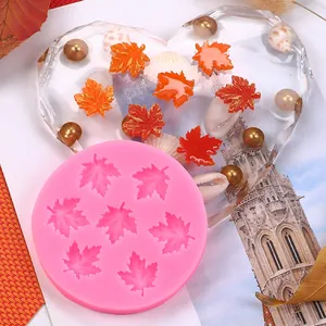 Detailed view of pink maple leaf silicone mold with finished resin decorations