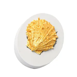 Detailed view of ocean series white silicone shell mold with a gold seashell cast