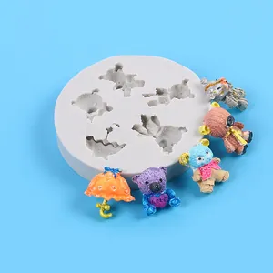 Detail view of white silicone mold for mini cartoon bears and umbrella DIY resin crafts