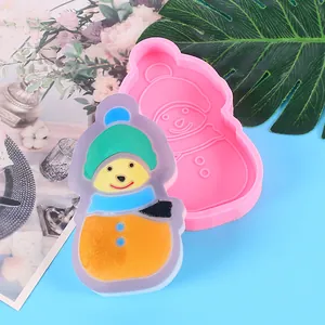 Detailed view of pink snowman silicone mold with a finished colorful resin snowman