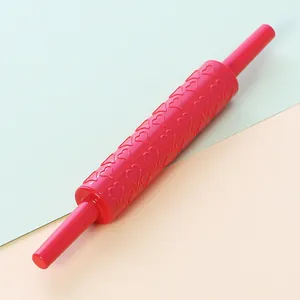 Red plastic fondant rolling pin with embossed heart patterns for DIY baking