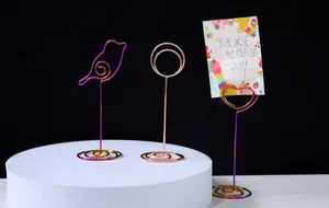 Set of creative metal wire memo holders in bird and heart shapes with rainbow iridescent finish.