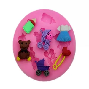 Detailed view of pink silicone mold with various baby-themed shapes for DIY crafts
