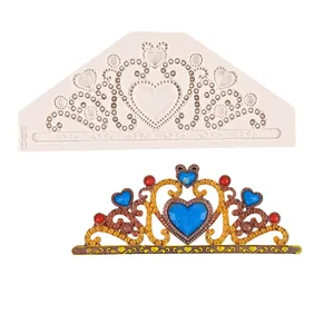 Detailed view of tiara silicone mold with finished gold and blue fondant crown