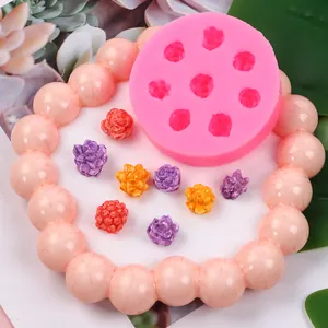 Detailed view of pink silicone mold with 3D flower and succulent fondant designs