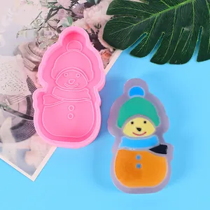Pink snowman silicone mold shown next to a colorful finished resin snowman decoration.