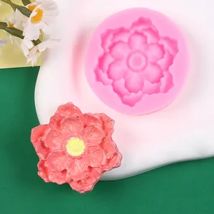 Close-up of pink silicone flower mold and finished resin sunflower decal for DIY crafts