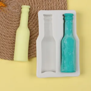 Detail view of 2-cavity bottle silicone mold with yellow and teal sample outputs