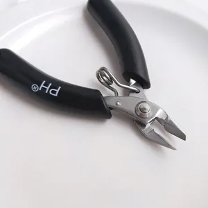 Close-up of stainless steel mini jewelry pliers with black non-slip handle.