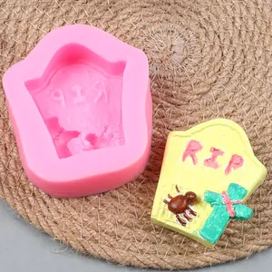 Detail of the pink silicone tombstone mold and finished resin craft with RIP text