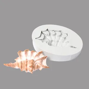 Detailed close-up of a conch-shaped silicone mold with a realistic seashell decoration sample.