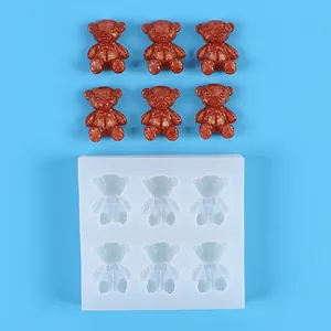 Detail view of 6-cavity mini teddy bear silicone mold with finished brown resin bears