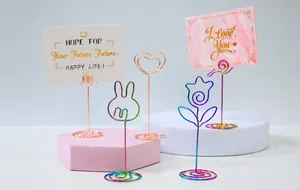 Detailed view of iridescent and rose gold metal memo clips in various cute shapes
