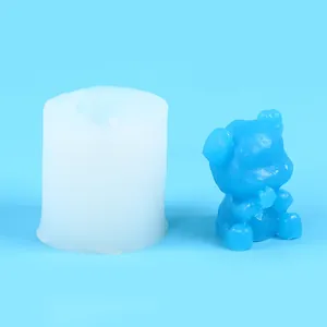 Close-up of a 3D bear silicone mold and a blue finished bear candle on blue background