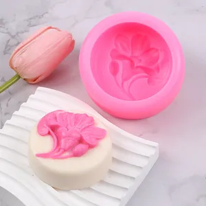 Detailed view of pink flower silicone mold with white floral craft soap.