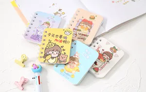 Detailed view of cute cartoon mini spiral notebooks with colorful covers and spiral binding.