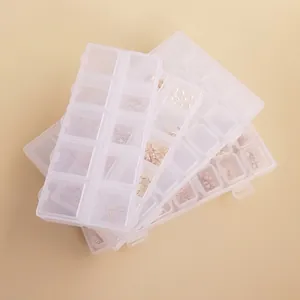 Stacked transparent plastic organizer boxes with individual grid lids for jewelry parts